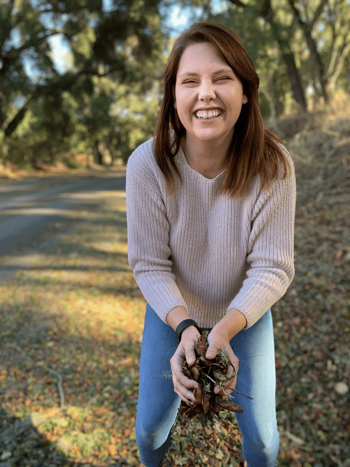 dakota with a handful of leaves