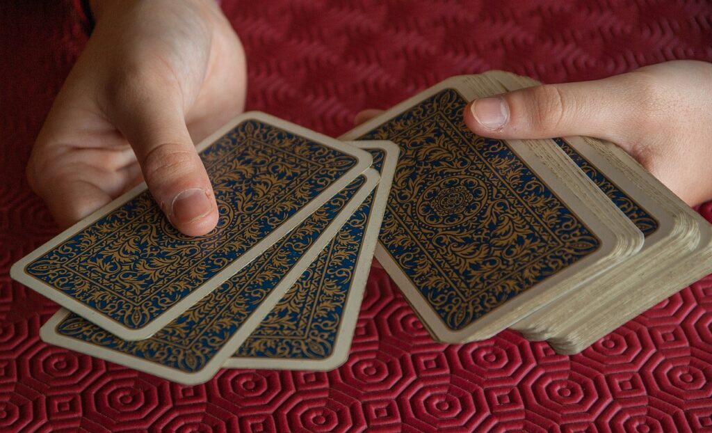 image of hands holding deck of cards